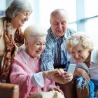 Group of seniors using mobile phone